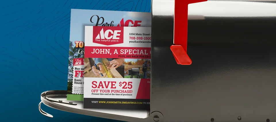 An open silver mailbox with a red flag containing colorful promotional flyers.